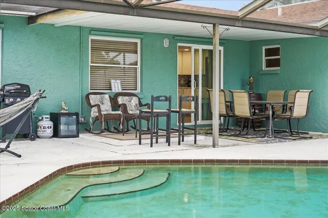 a view of swimming pool with outdoor seating