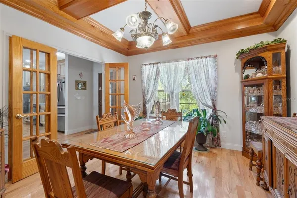 a view of a dining room with furniture and chandelier