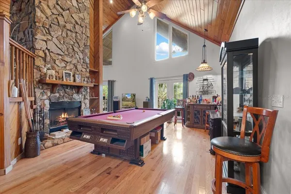 a living room with furniture a flat screen tv and a table