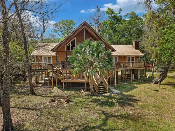 a view of a deck with wooden floor and outdoor seating