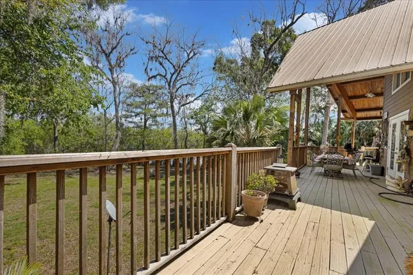 a view of a patio with table and chairs and wooden floor