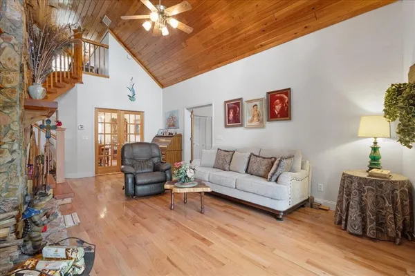 a living room with furniture and wooden floor