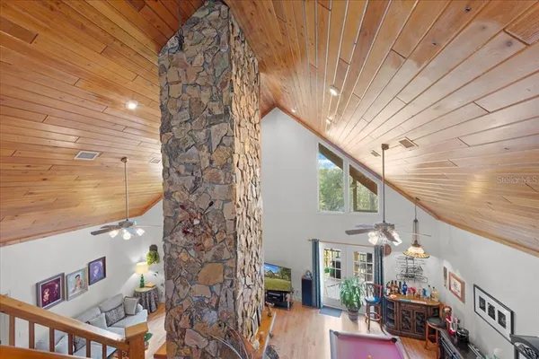 a living room with furniture chess board and large windows