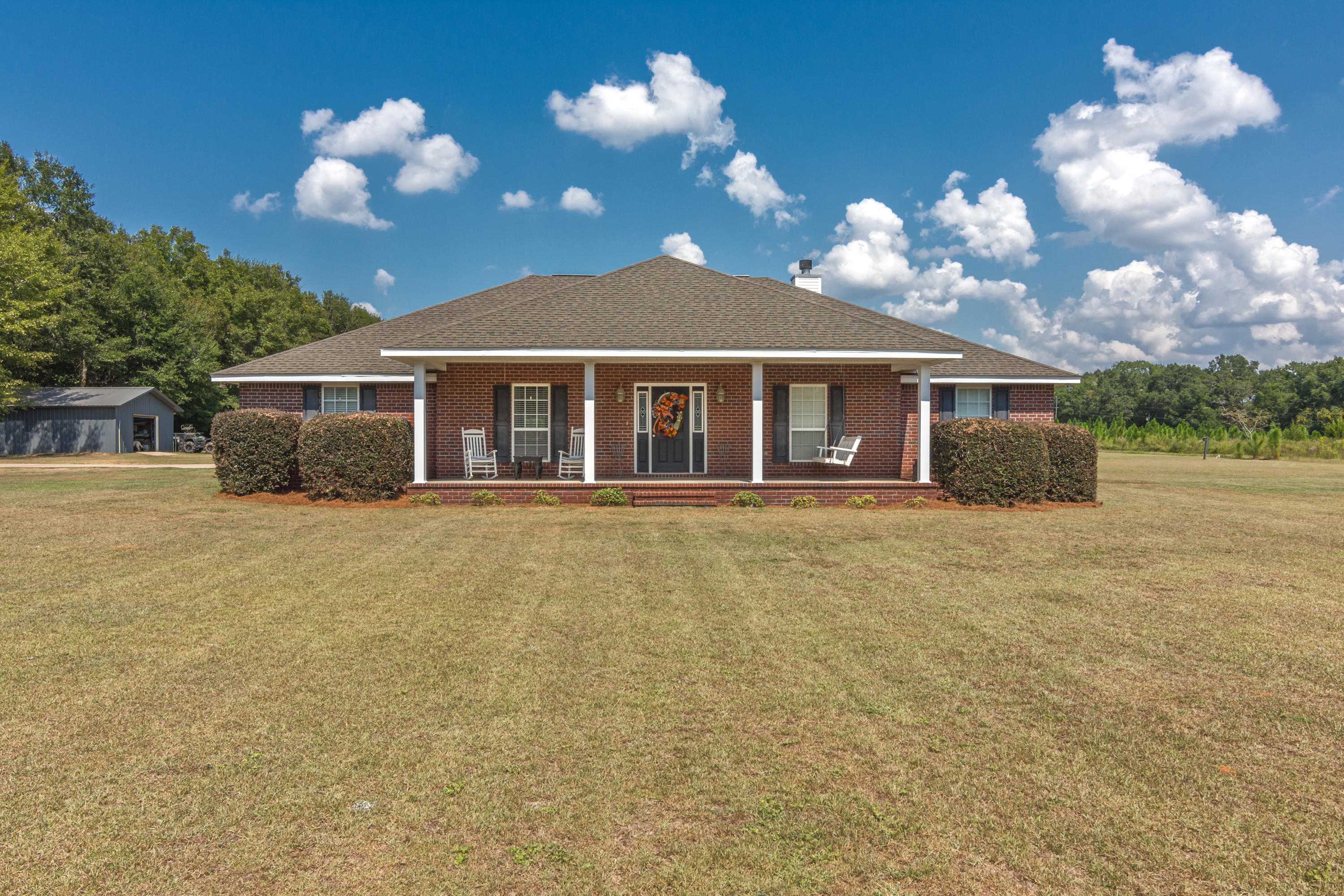 5803 Bush Road Baker, FL 32531 - Photo 2 of 34 a view of a house with a balcony and a large tree