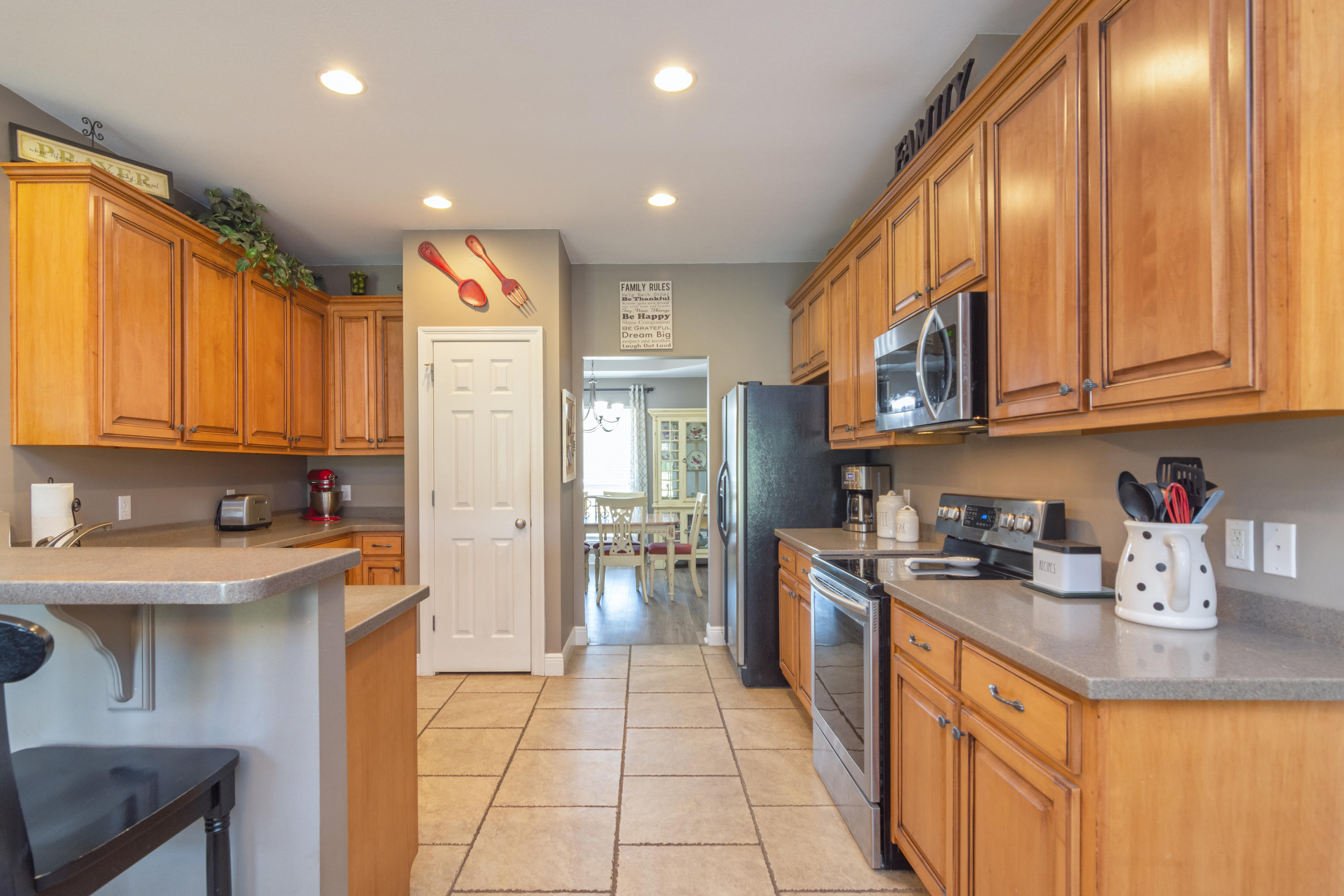 5803 Bush Road Baker, FL 32531 - Photo 11 of 34 a kitchen with stainless steel appliances granite countertop a refrigerator and a stove top oven