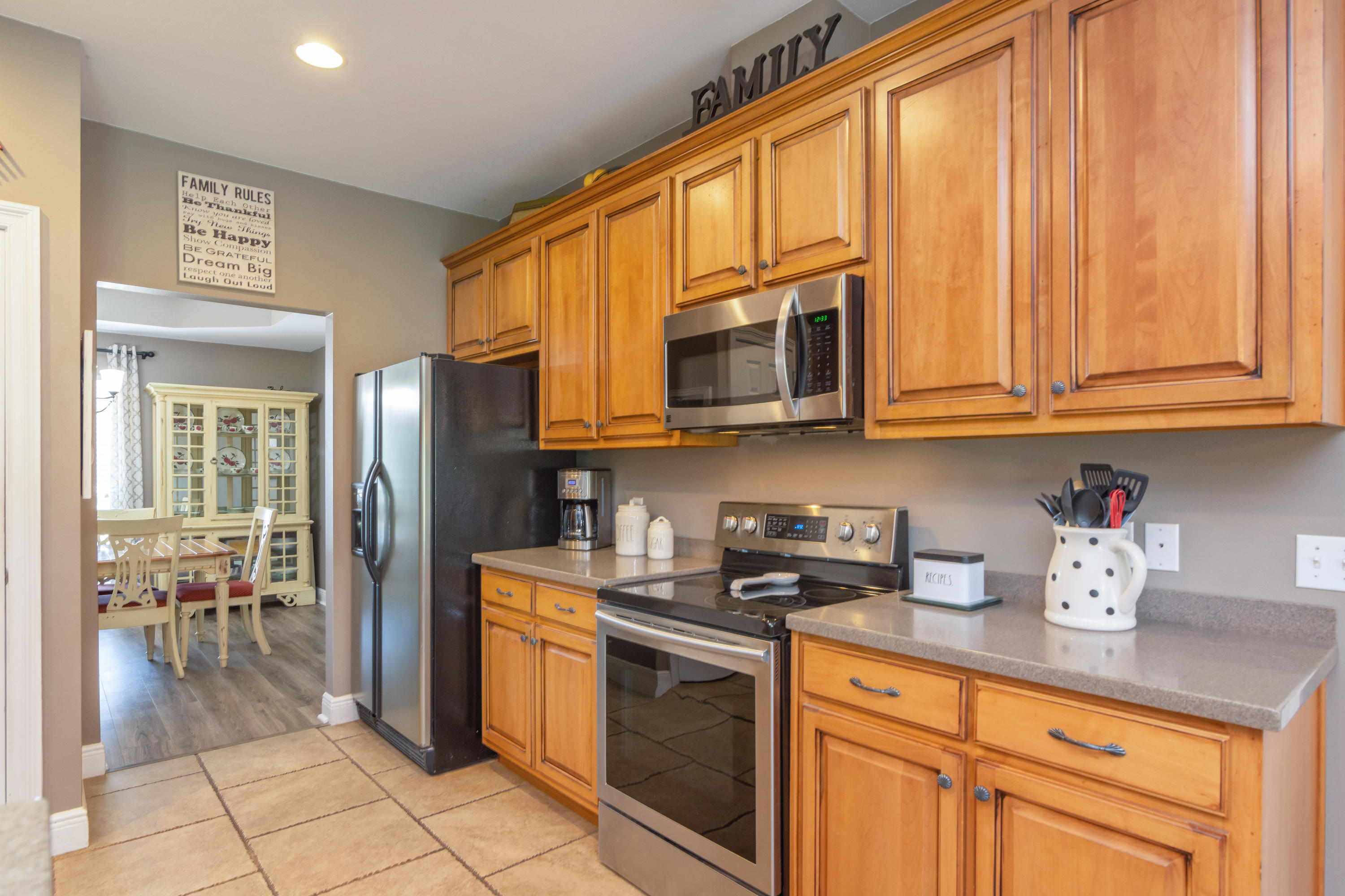 5803 Bush Road Baker, FL 32531 - Photo 12 of 34 a kitchen with stainless steel appliances granite countertop a stove a sink dishwasher and a refrigerator with cabinets