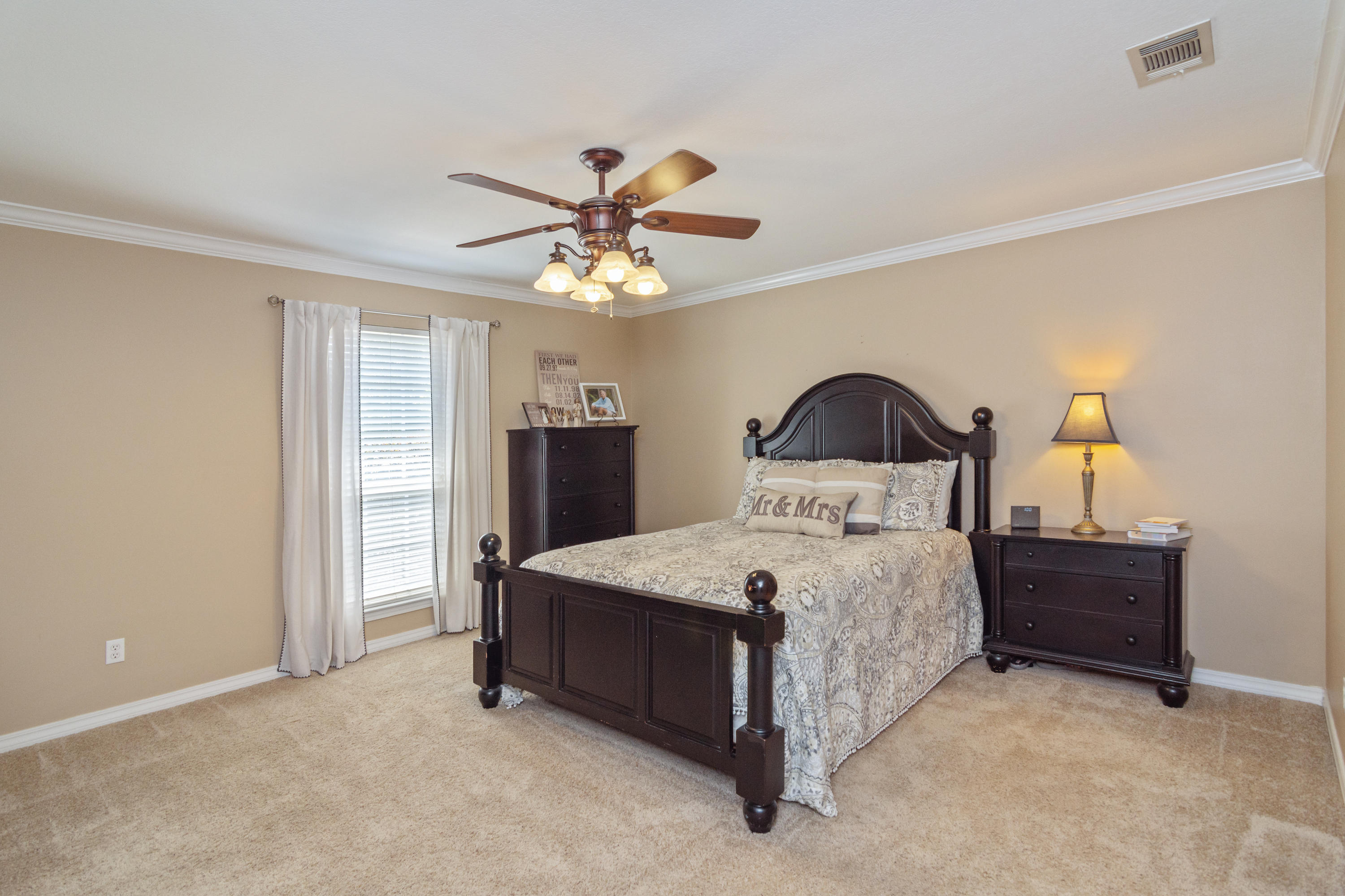 5803 Bush Road Baker, FL 32531 - Photo 18 of 34 a bedroom with a bed and a chandelier