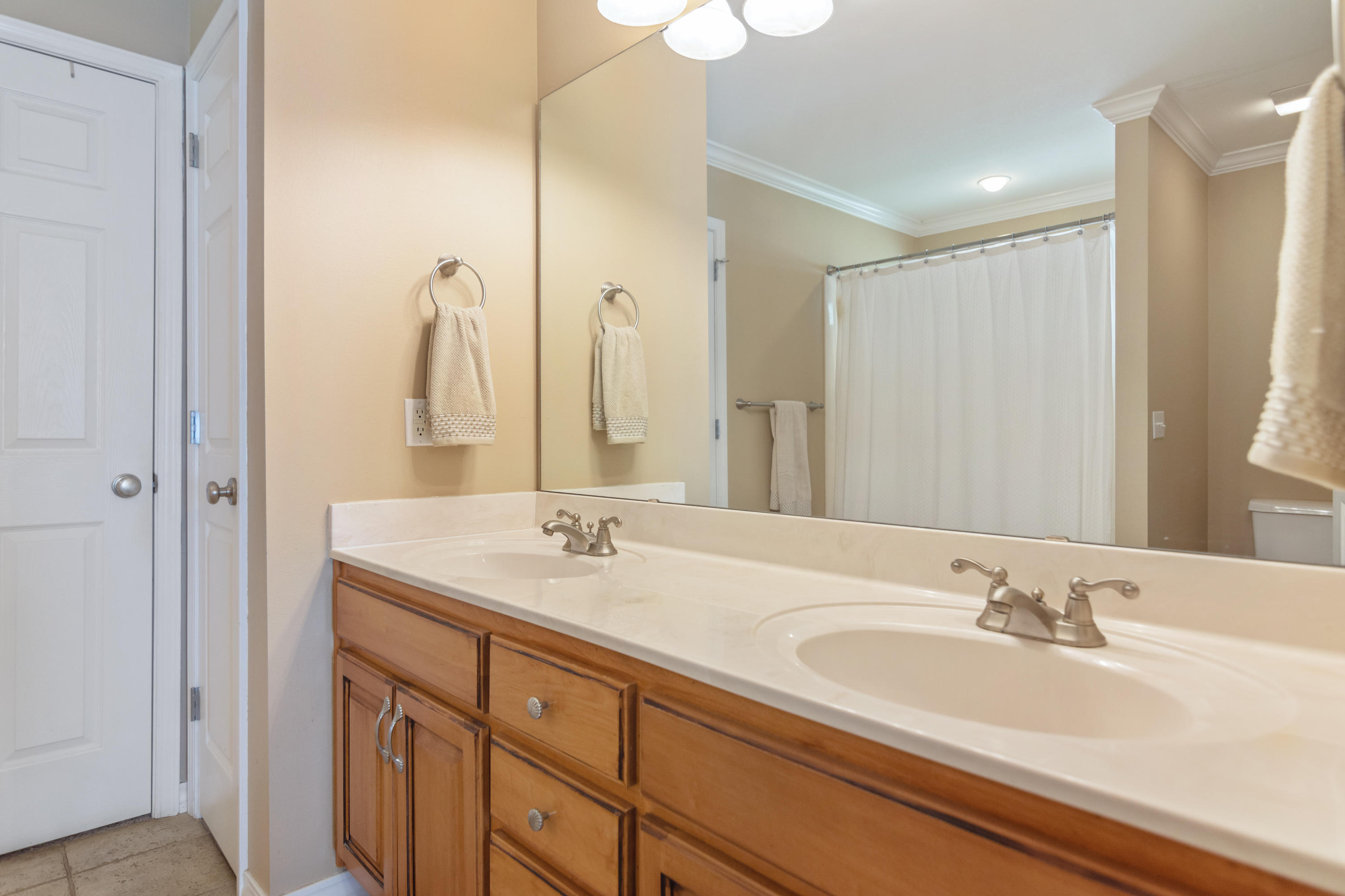 5803 Bush Road Baker, FL 32531 - Photo 20 of 34 a bathroom with a double vanity sink and a mirror