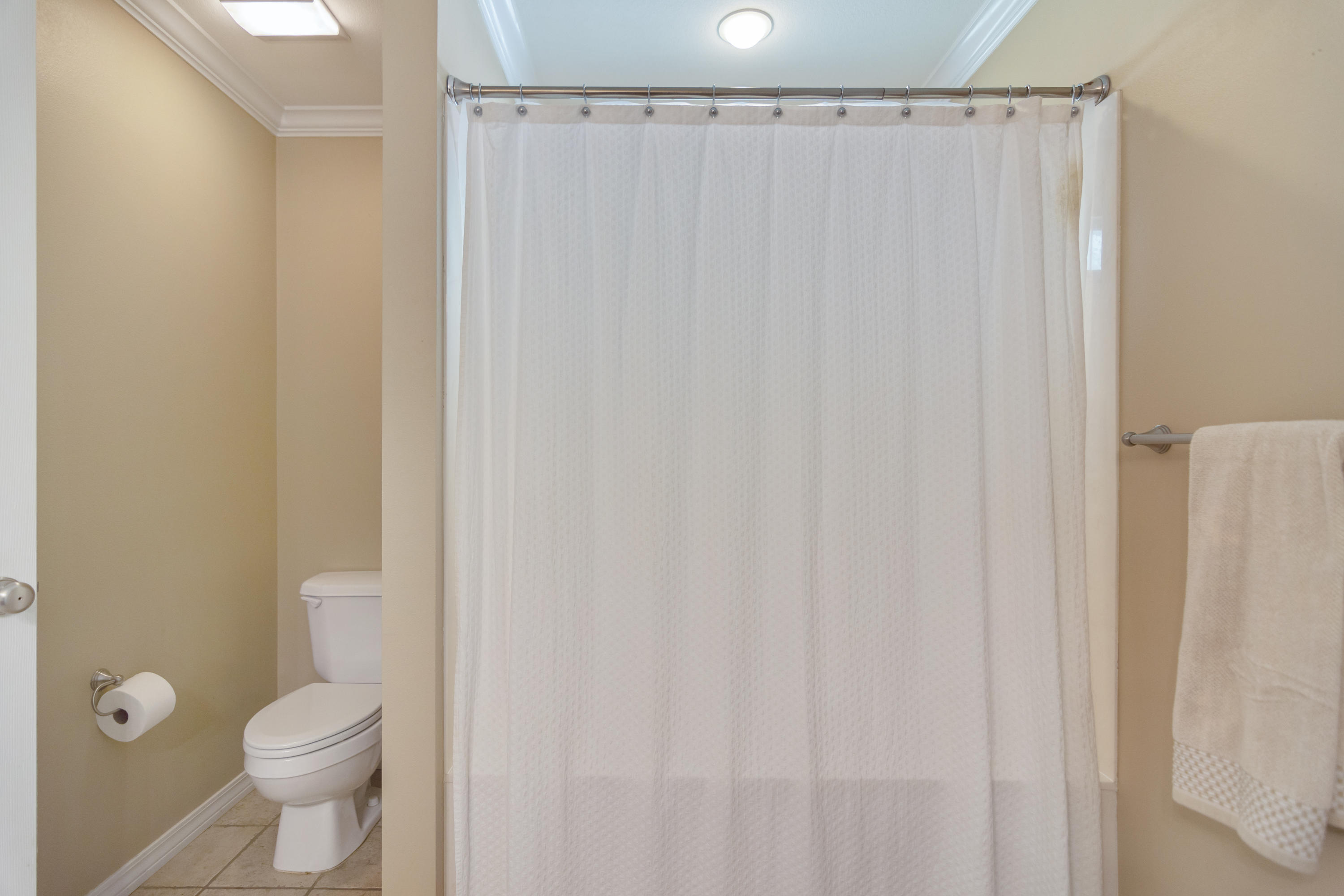 5803 Bush Road Baker, FL 32531 - Photo 23 of 34 a bathroom with a shower curtain and a toilet