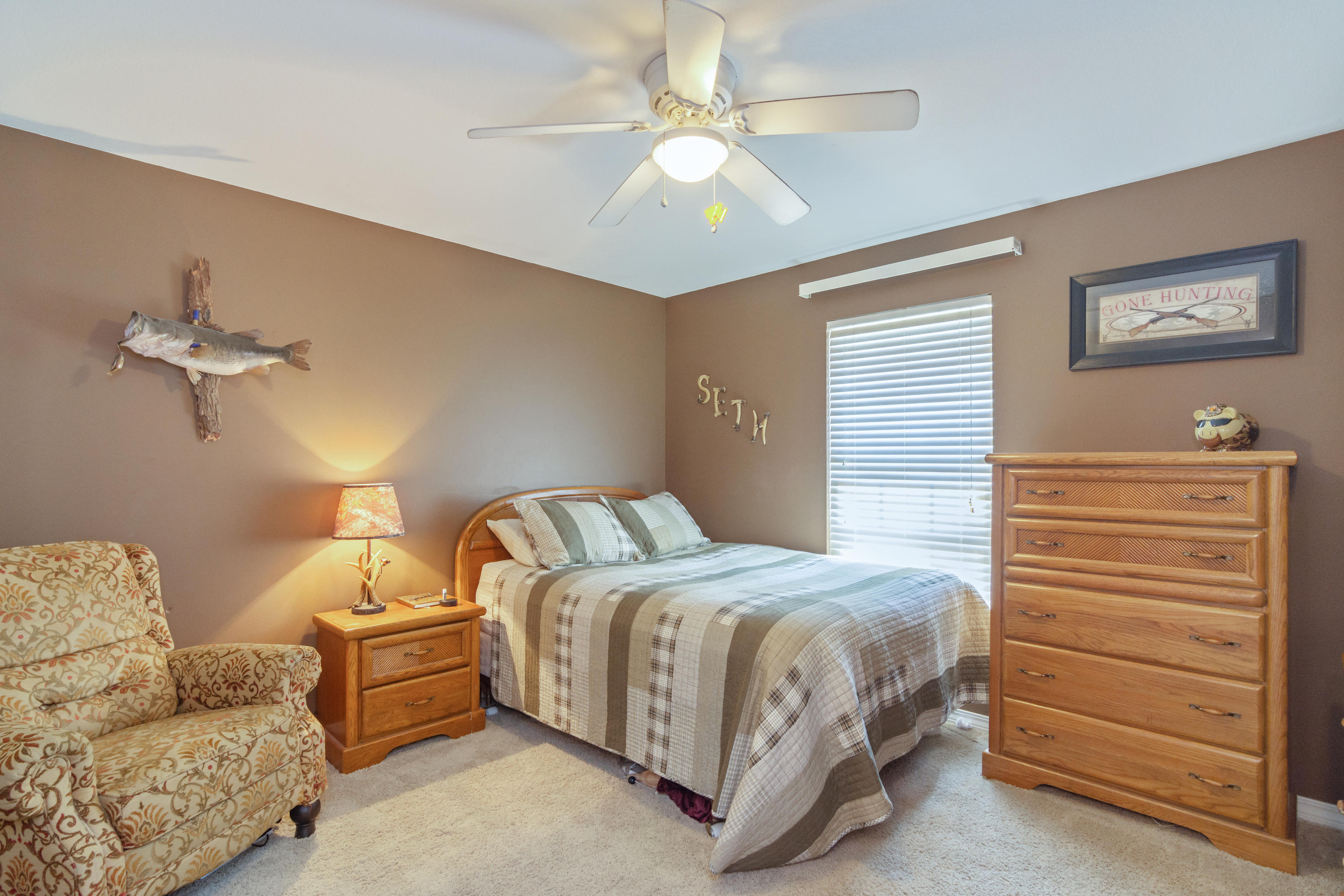 5803 Bush Road Baker, FL 32531 - Photo 24 of 34 a bedroom with a bed and a chandelier