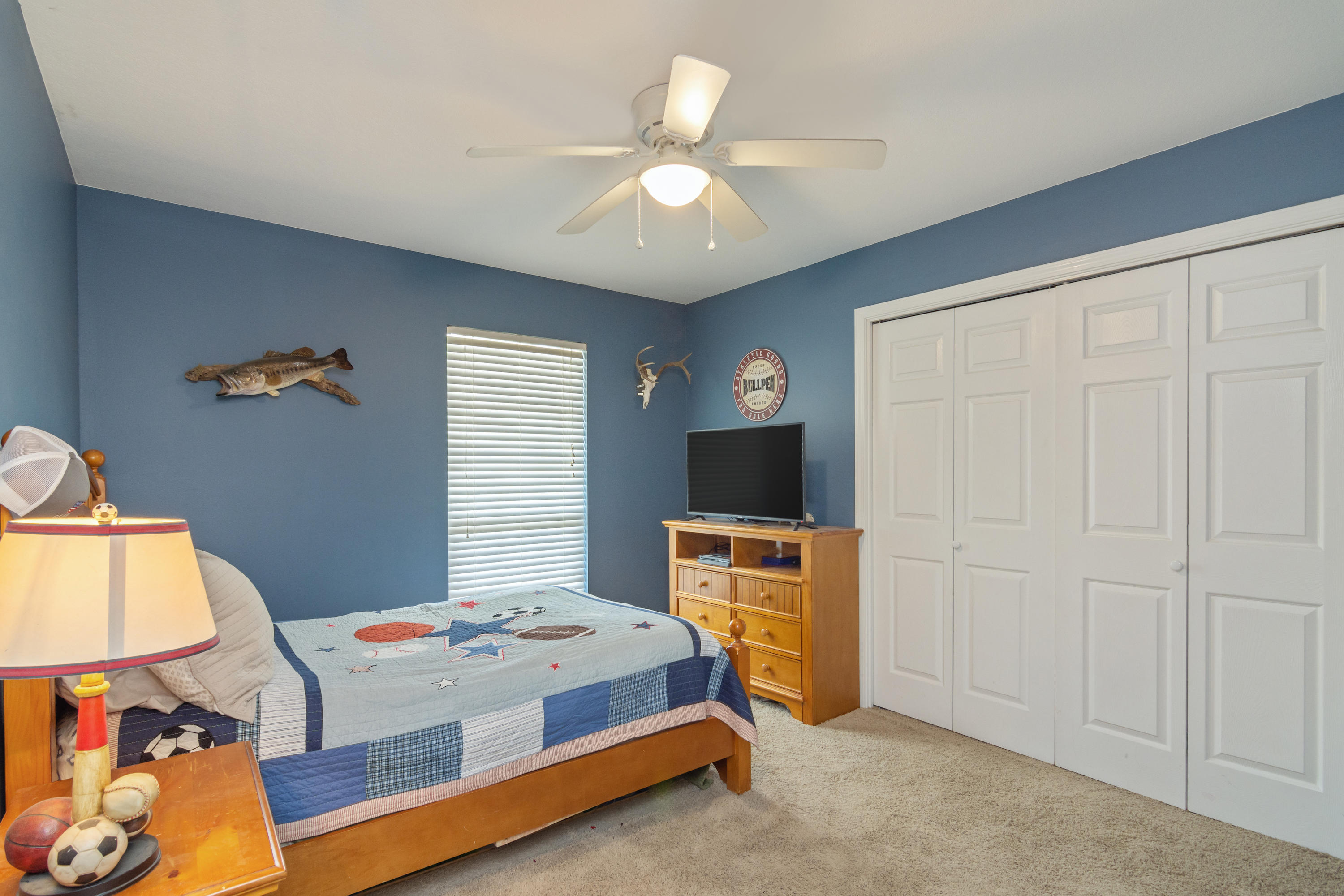 5803 Bush Road Baker, FL 32531 - Photo 25 of 34 a bedroom with a bed and a chandelier