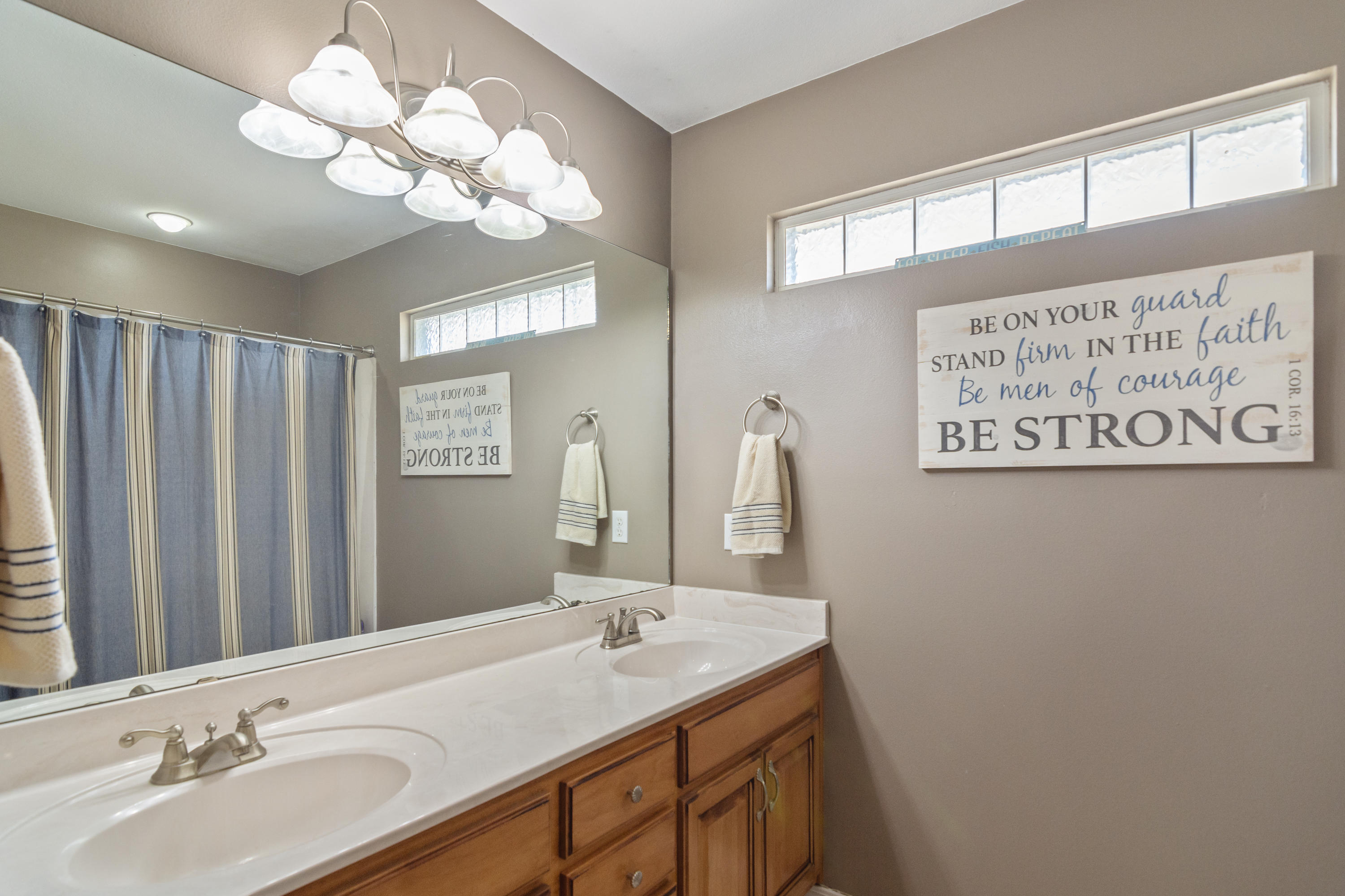 5803 Bush Road Baker, FL 32531 - Photo 28 of 34 a bathroom with a double vanity sink and a mirror