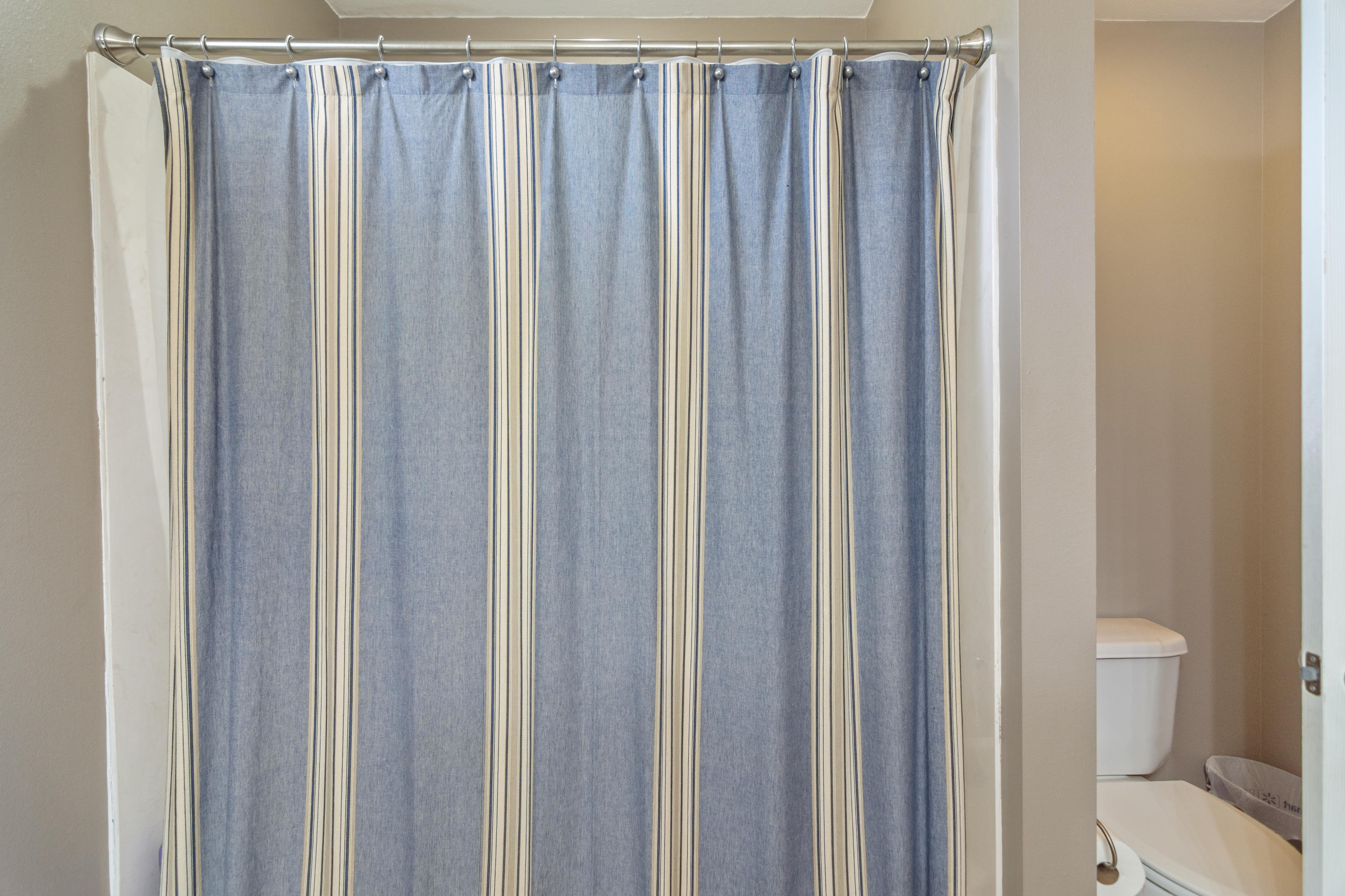 5803 Bush Road Baker, FL 32531 - Photo 30 of 34 a bathroom with a shower curtain and a toilet