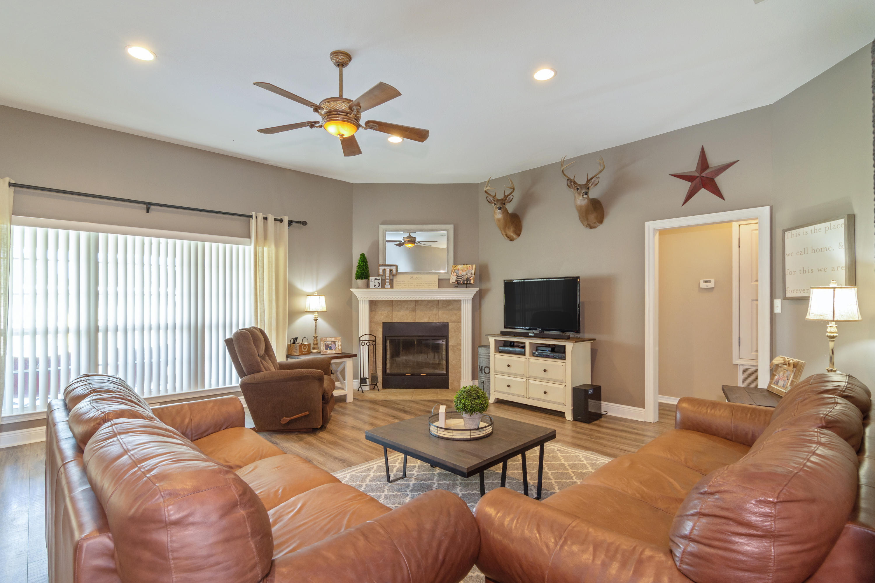 5803 Bush Road Baker, FL 32531 - Photo 6 of 34 a living room with furniture a fireplace and a flat screen tv