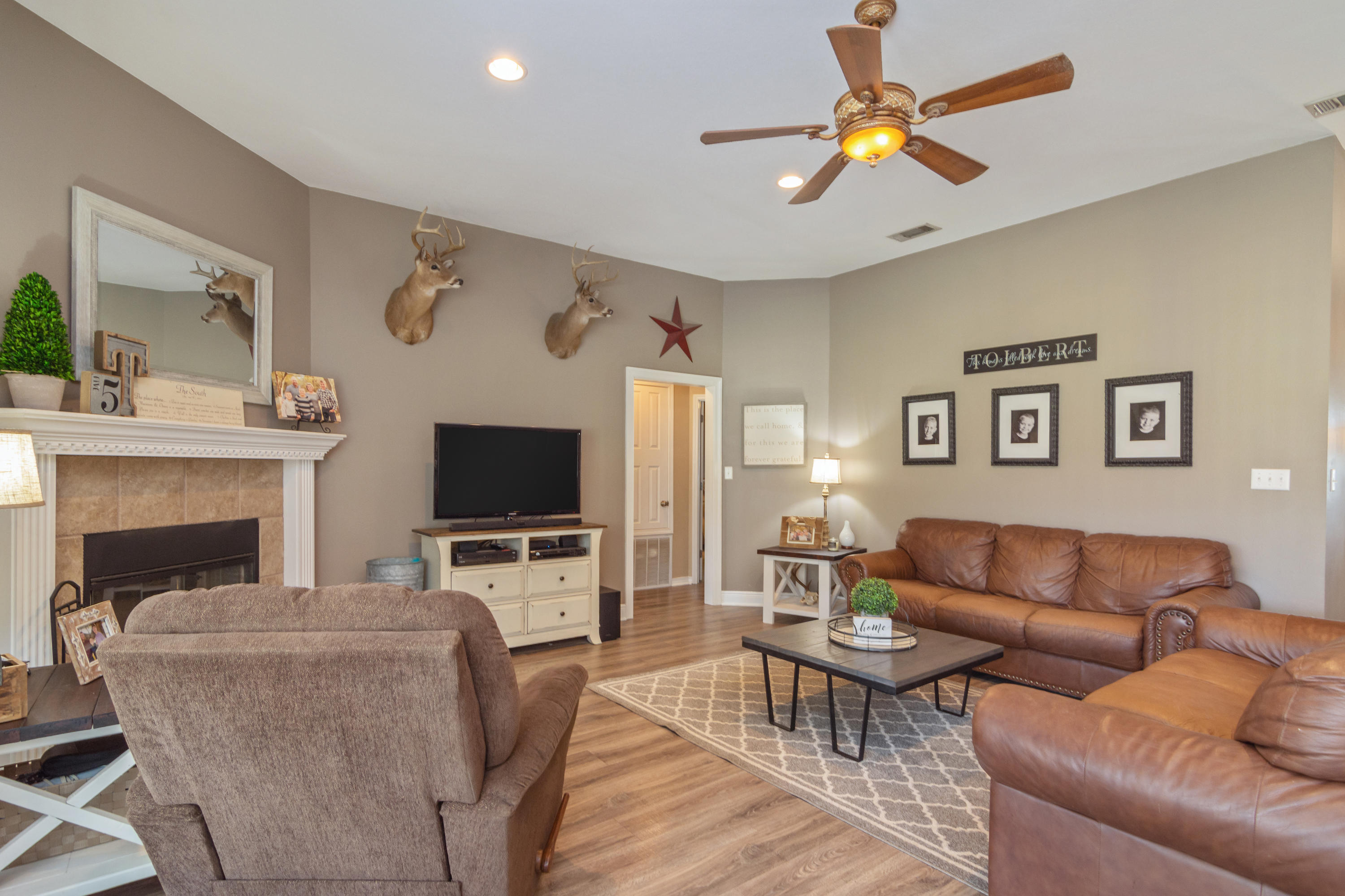 5803 Bush Road Baker, FL 32531 - Photo 8 of 34 a living room with furniture a fireplace and a flat screen tv