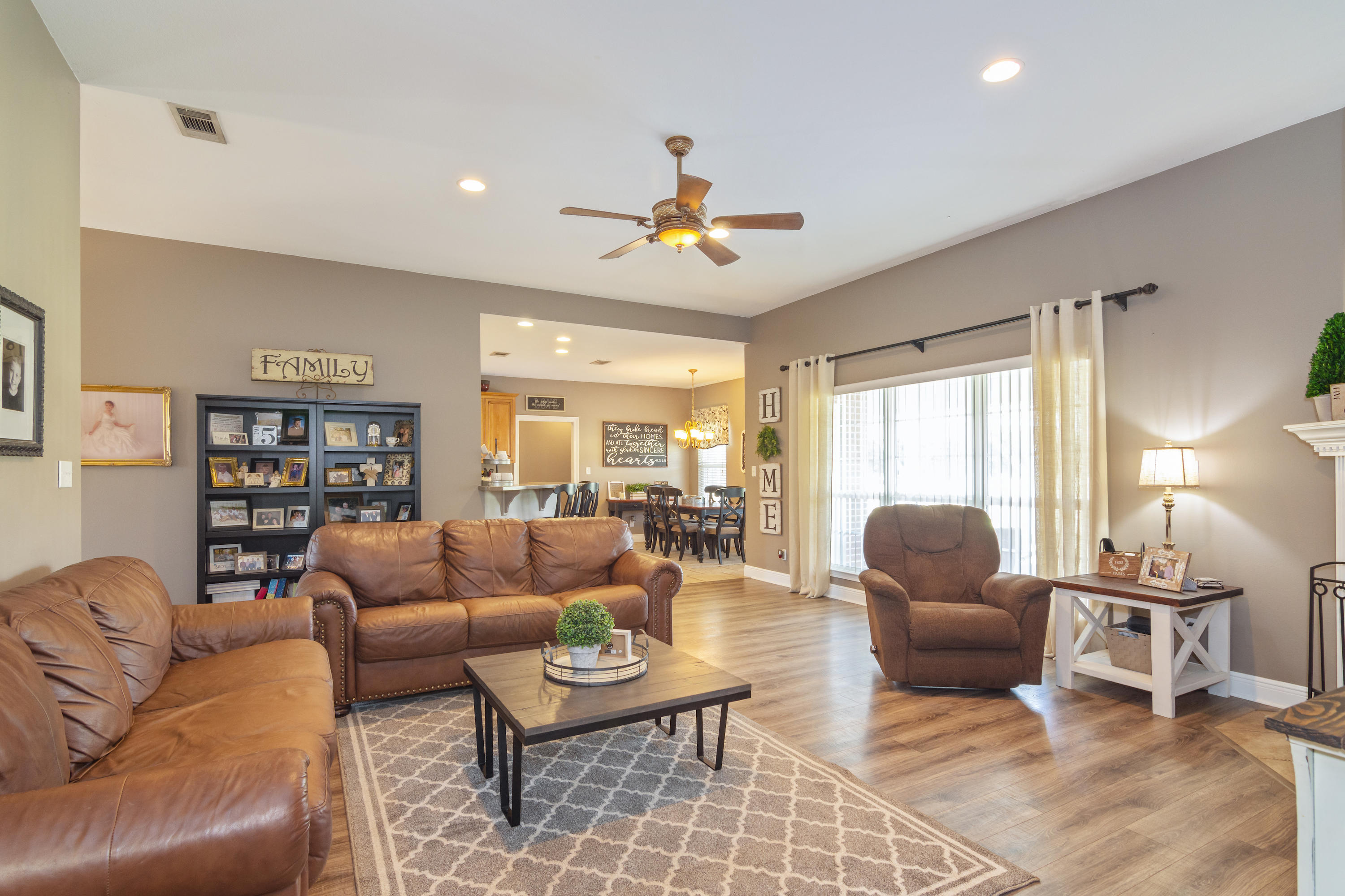 5803 Bush Road Baker, FL 32531 - Photo 9 of 34 a living room with furniture a rug and a chandelier