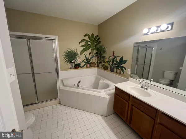 a bathroom with a tub sink and mirror