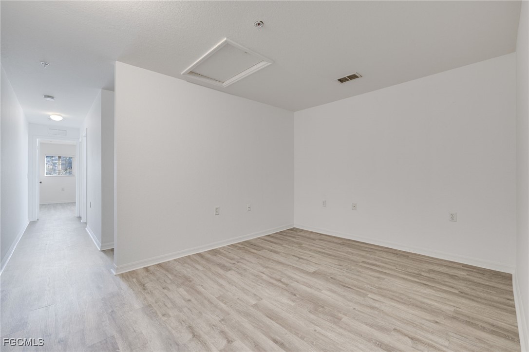 9470 Ivy Brook Run, Unit 805 Fort Myers, FL 33913 - Photo 11 of 31 wooden floor in an empty room
