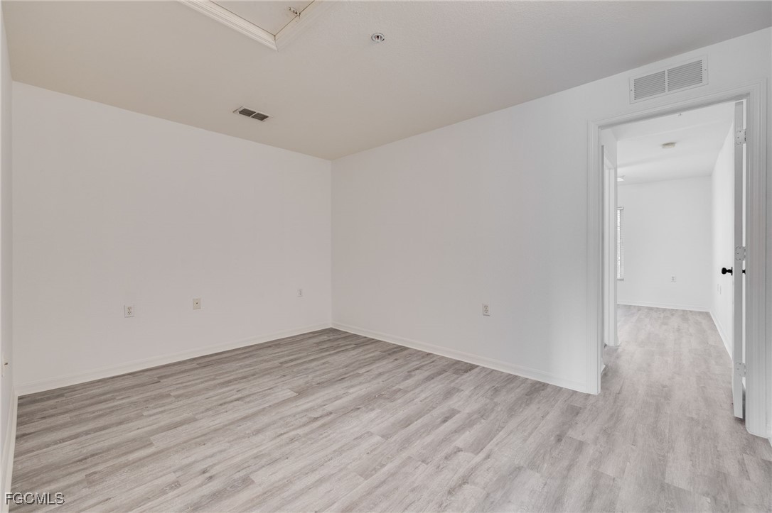 9470 Ivy Brook Run, Unit 805 Fort Myers, FL 33913 - Photo 12 of 31 a view of an empty room with wooden floor