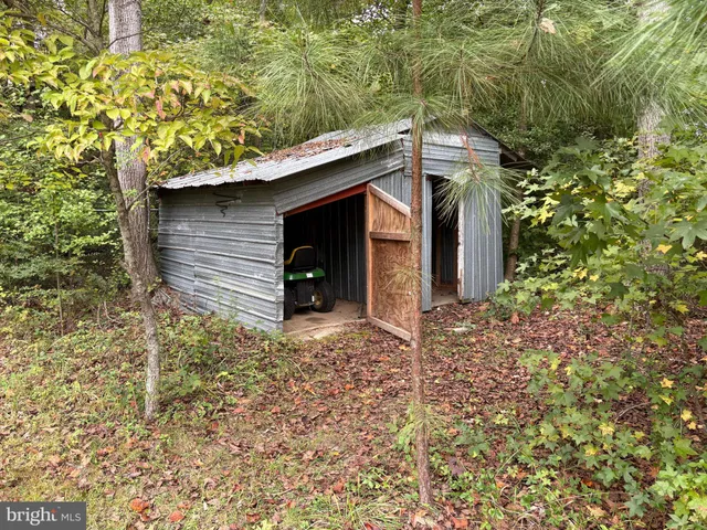 a yellow house with tree in front of it