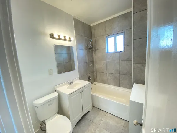 a bathroom with a toilet a sink and bathtub