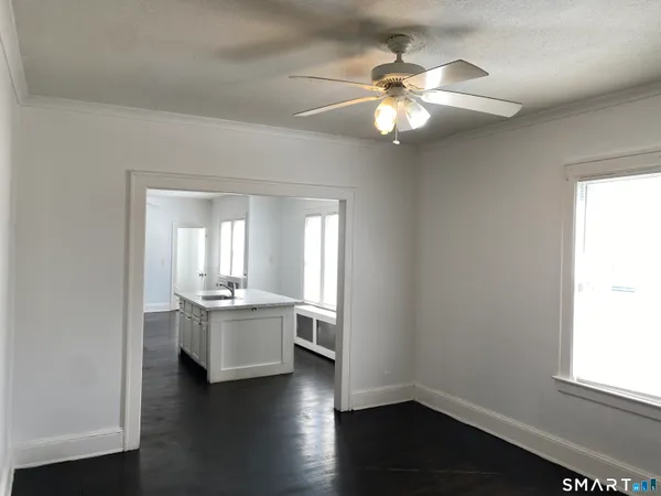 a view of a room with wooden floor and a window