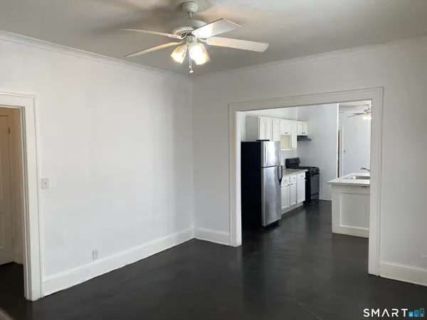 a view of a kitchen with a sink and a refrigerator