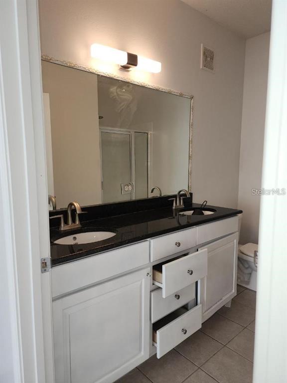5255 Cane Island Loop, Unit 304 Kissimmee, FL 34746 - Photo 6 of 14 a bathroom with a sink and a mirror
