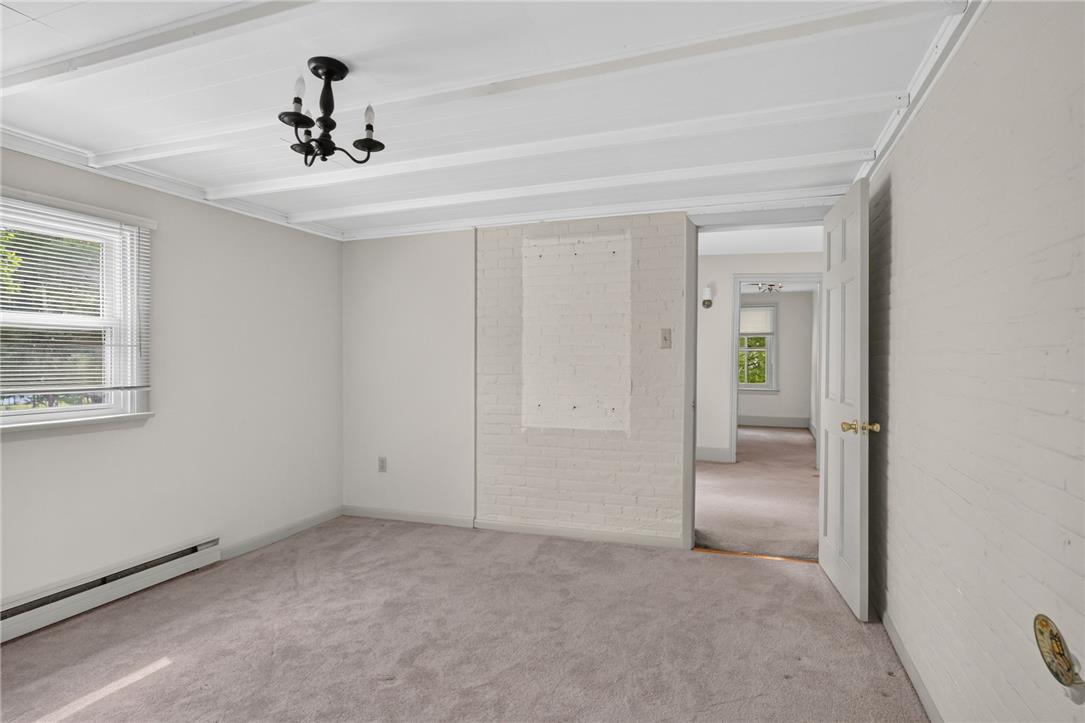 765 East Macada Road Bethlehem, PA 18017 - Photo 31 of 46 A well-lit bedroom with neutral carpet and exposed ceiling beams offers a versatile living space.