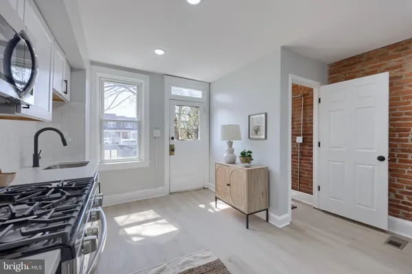 a view of a sink and dishwasher with wooden floor