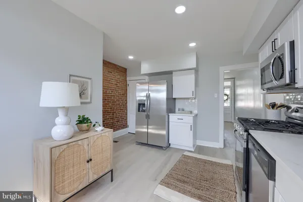 a kitchen with stainless steel appliances a sink stove and refrigerator
