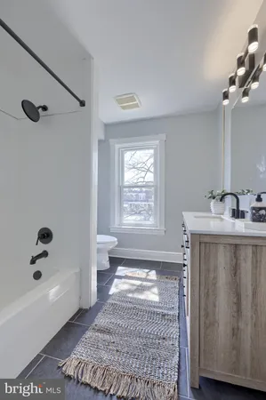a bathroom with a bathtub a shower a toilet and a sink
