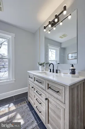 a bathroom with a double vanity sink and a mirror