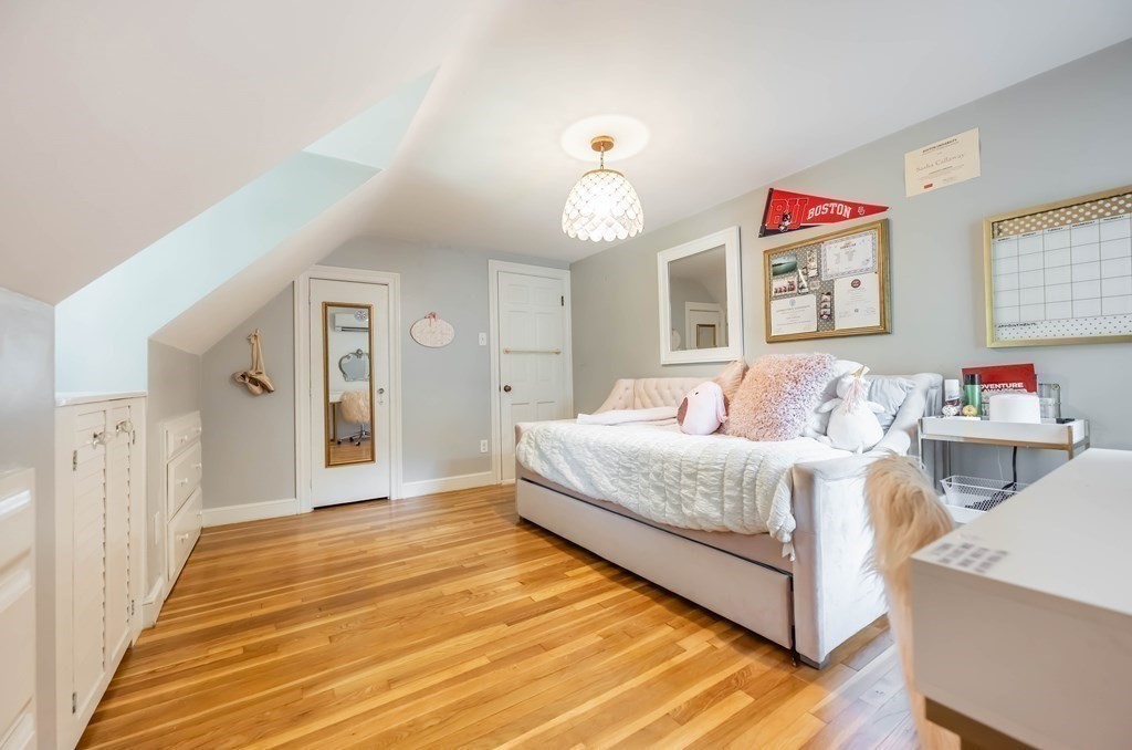 237 Highland Road Andover, MA 01810 - Photo 25 of 42 a bedroom with a bed and a chandelier