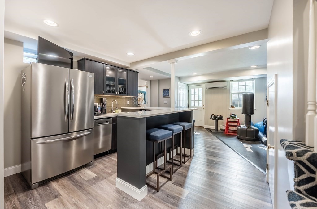 237 Highland Road Andover, MA 01810 - Photo 28 of 42 a kitchen with stainless steel appliances granite countertop a refrigerator a sink dishwasher a stove and a refrigerator with wooden floor