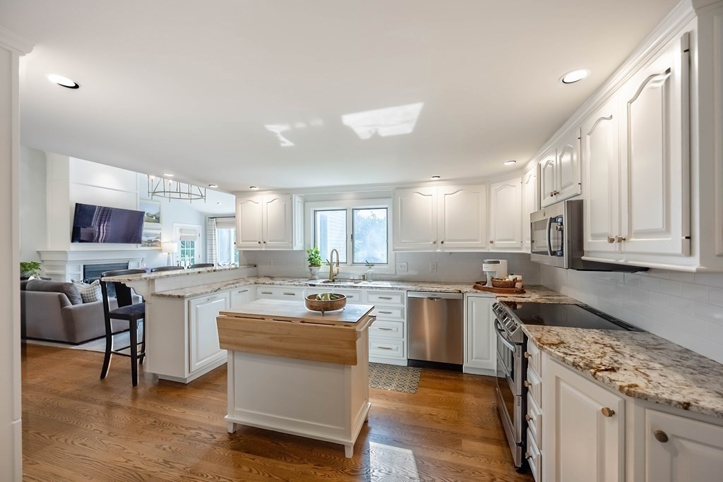237 Highland Road Andover, MA 01810 - Photo 8 of 42 a kitchen with a sink stove and cabinets