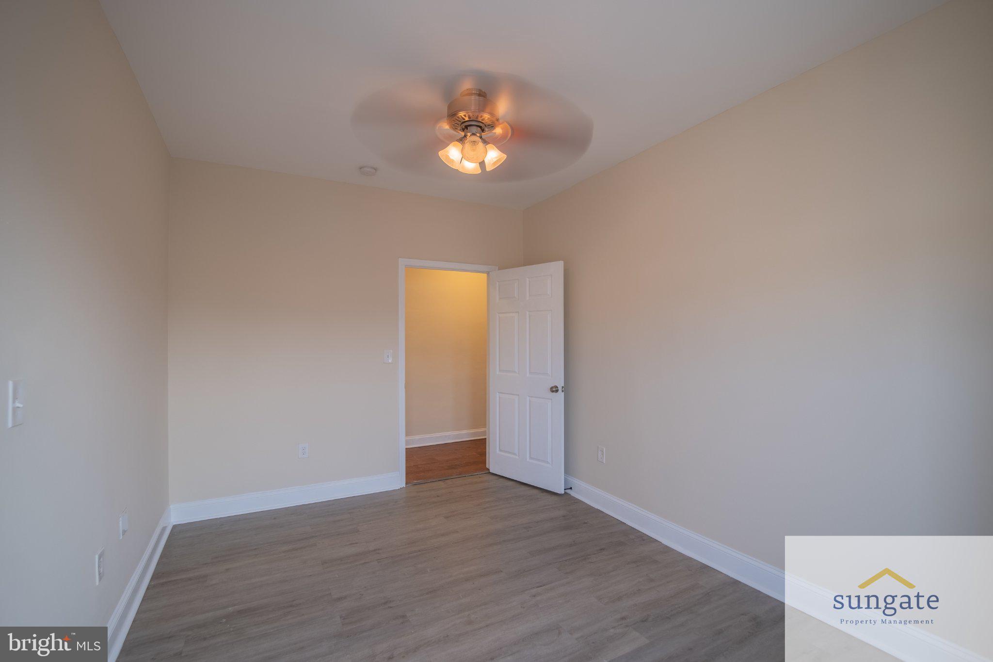 4032 Falls Road, Unit 2 Baltimore, MD 21211 - Photo 19 of 30 a view of an empty room with a chandelier fan