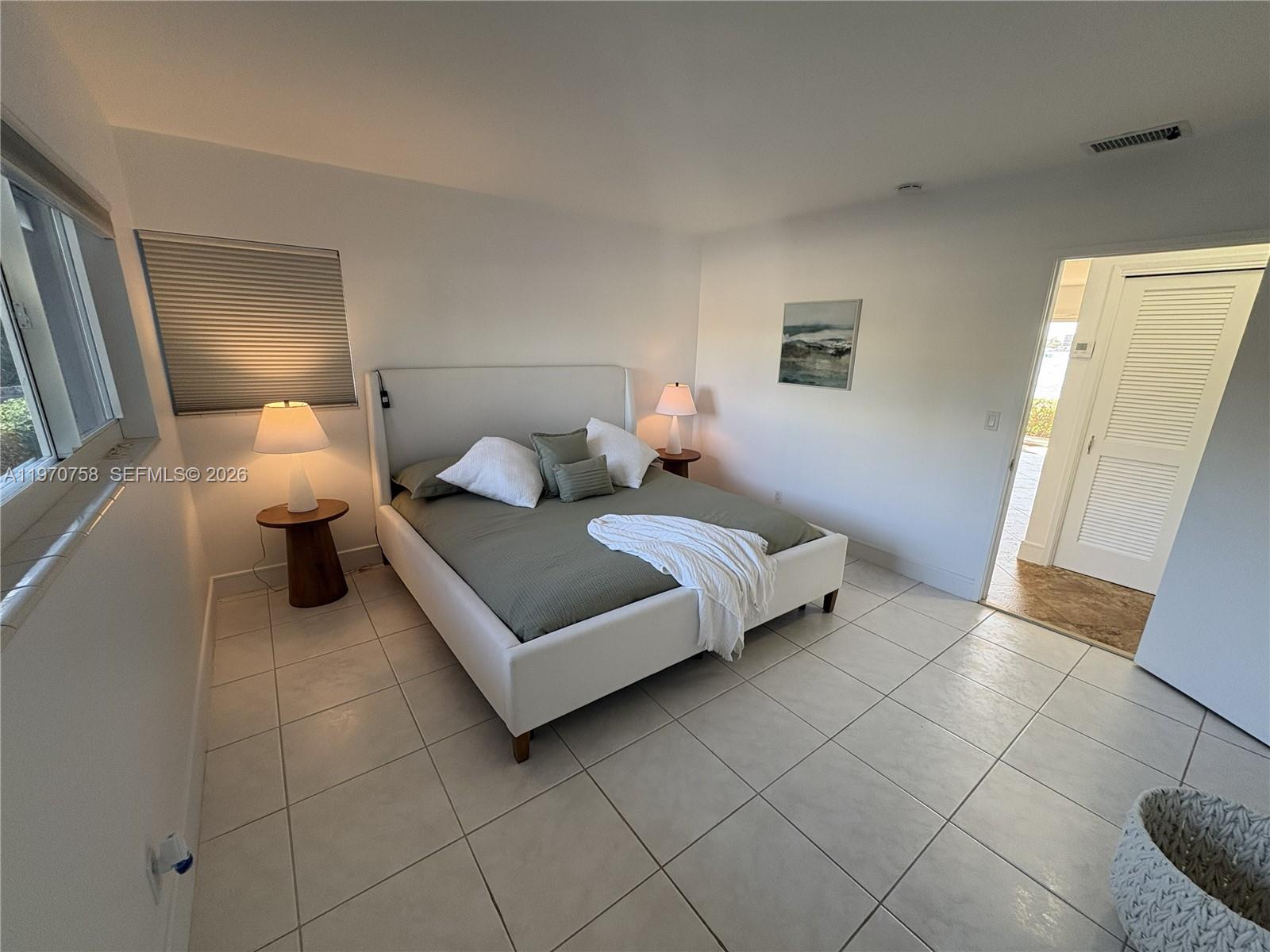 1201 South Riverside Drive, Unit 107 Pompano Beach, FL 33062 - Photo 14 of 27 a bedroom with a bed and walk in closet