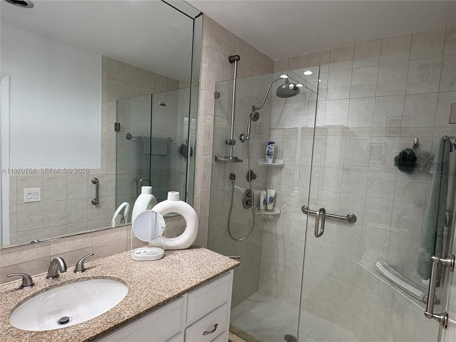 1201 South Riverside Drive, Unit 107 Pompano Beach, FL 33062 - Photo 16 of 27 a bathroom with a sink vanity granite tub and shower