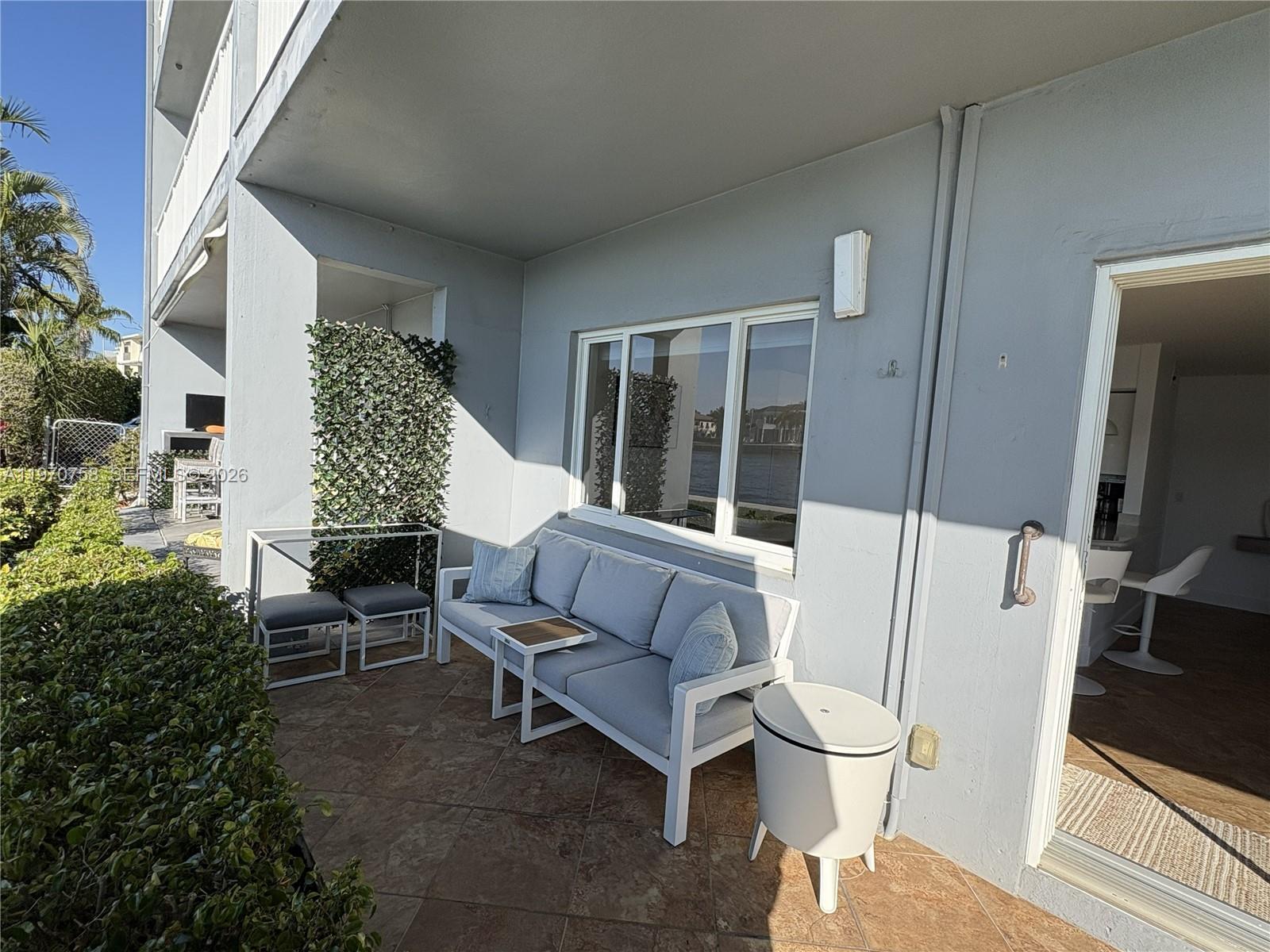 1201 South Riverside Drive, Unit 107 Pompano Beach, FL 33062 - Photo 19 of 27 a living room with furniture and a flat screen tv