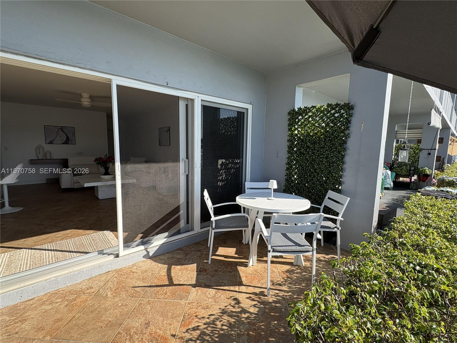 1201 South Riverside Drive, Unit 107 Pompano Beach, FL 33062 - Photo 20 of 27 a view of a dinning table and chairs in porch