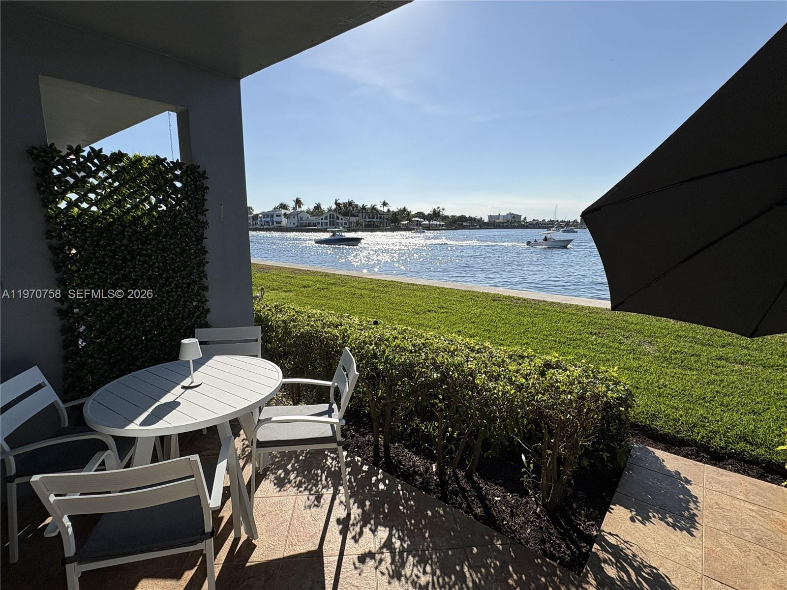 1201 South Riverside Drive, Unit 107 Pompano Beach, FL 33062 - Photo 22 of 27 a view of a balcony with chairs