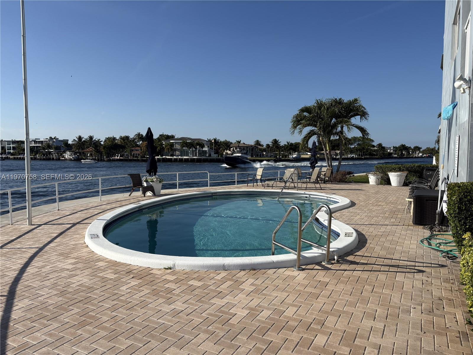 1201 South Riverside Drive, Unit 107 Pompano Beach, FL 33062 - Photo 25 of 27 a view of a swimming pool with a lounge chair