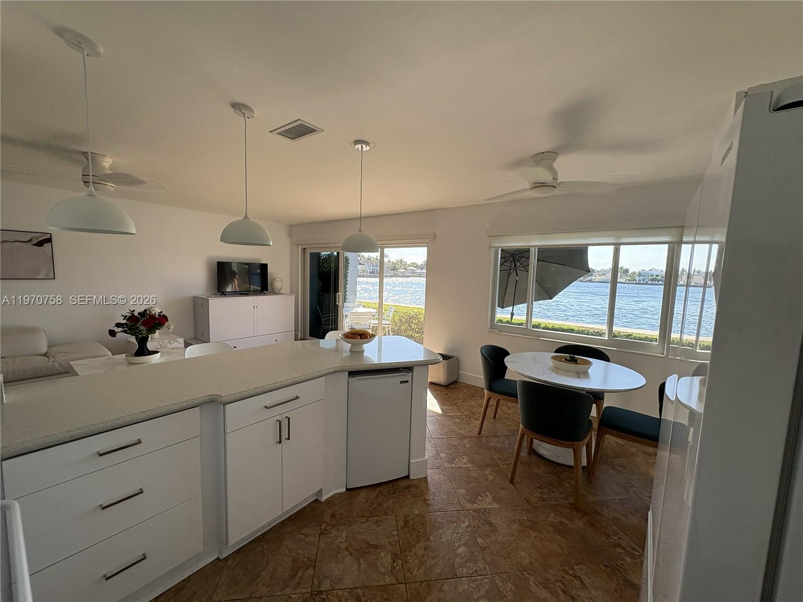 1201 South Riverside Drive, Unit 107 Pompano Beach, FL 33062 - Photo 6 of 27 a kitchen with sink and view of living room