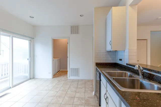 a kitchen with a sink and a refrigerator