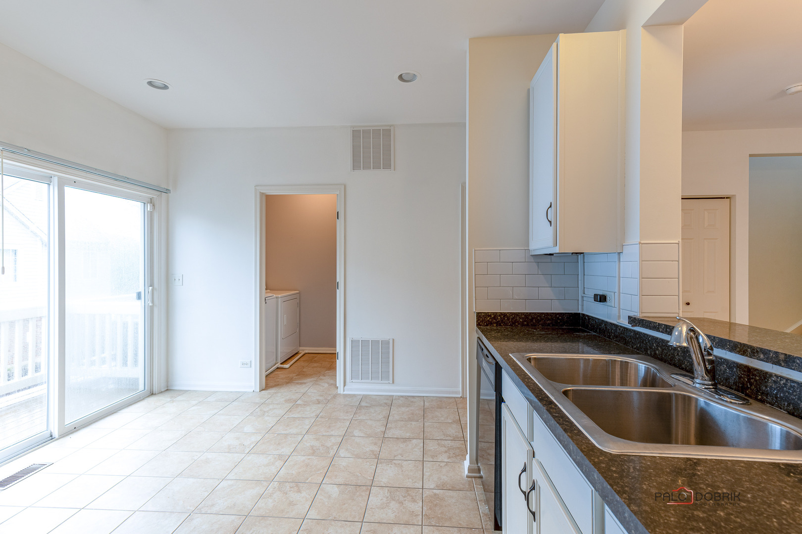 3410 Cameron Drive Elgin, IL 60124 - Photo 12 of 28 a kitchen with a sink and a refrigerator