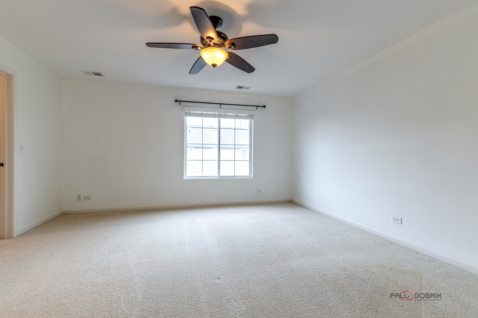 3410 Cameron Drive Elgin, IL 60124 - Photo 17 of 28 an empty room with a window and a ceiling fan