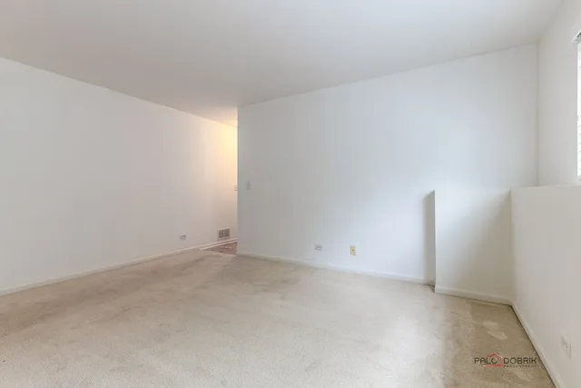 a view of staircase with white walls and white door