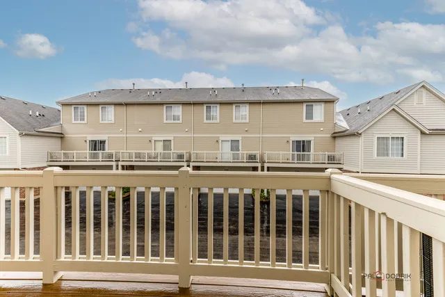 a view of a house with wooden deck