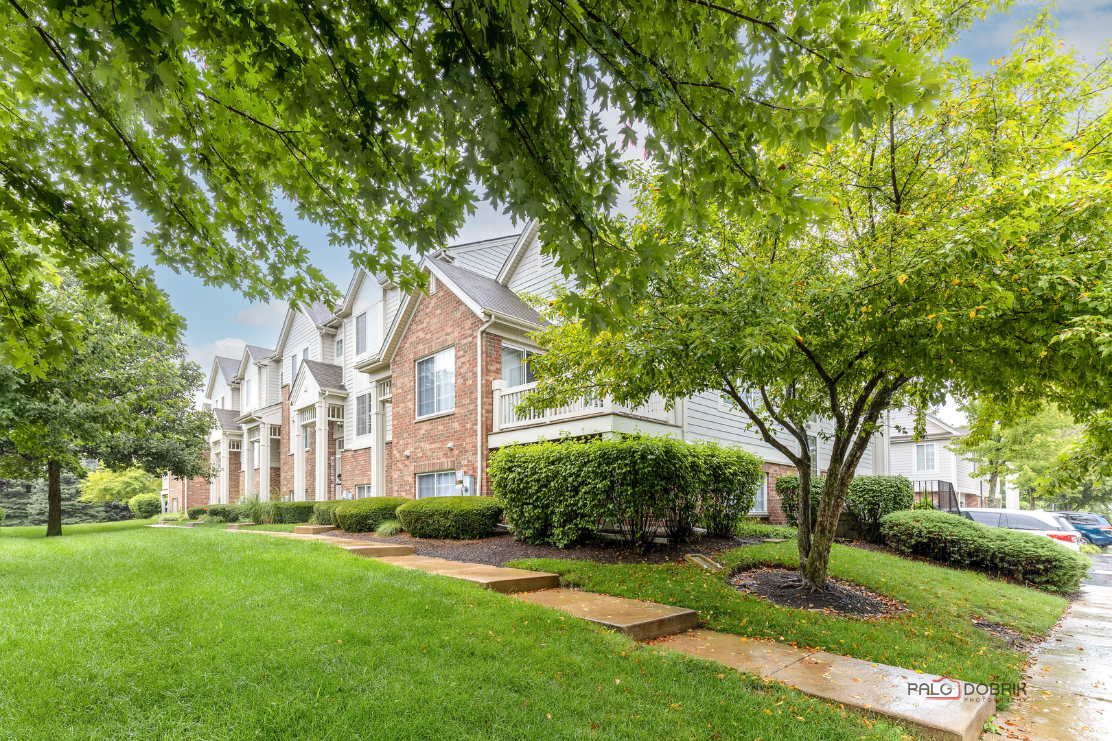 3410 Cameron Drive Elgin, IL 60124 - Photo 3 of 28 a view of a white house next to a yard with big trees